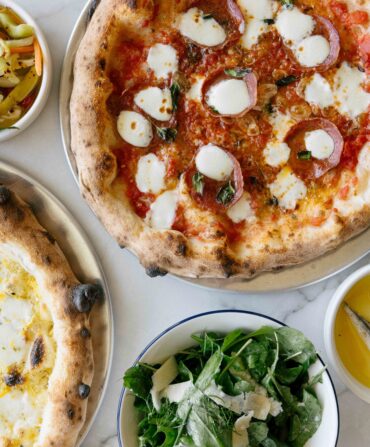 Two pizzas and three side dishes