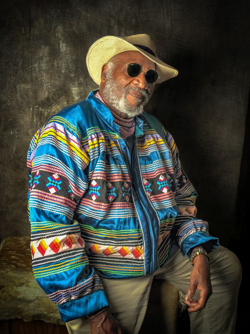 A portrait of a man with a colorful jacket