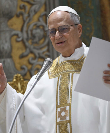 The new pope speaking at a microphone