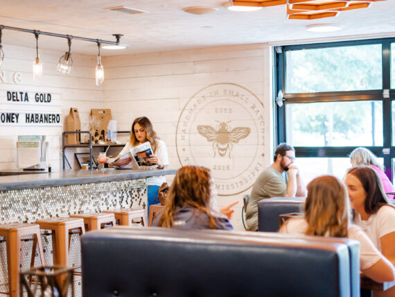 Inside a meadery shop with booths and people seated