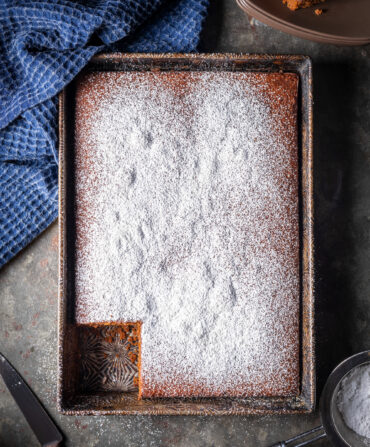 A pan of brown cake with powdered sugar on top