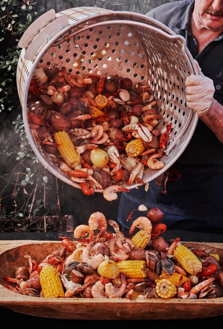 A man pours out a seafood boil