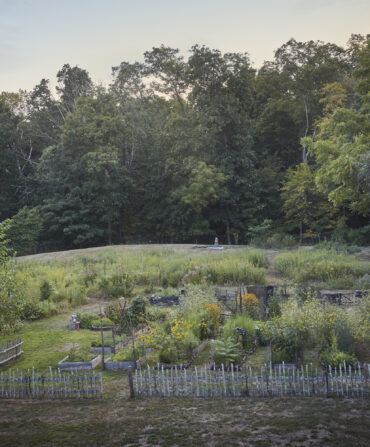 An aerial view of a vegetable garden with a stick fence