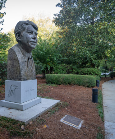 A statue of Jimmy Carter's head stands in a garden