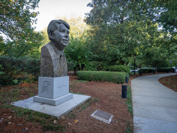 A statue of Jimmy Carter's head stands in a garden