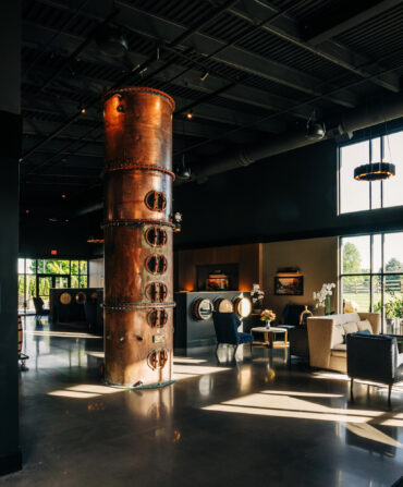 A hotel lobby with a polished interior and copper still