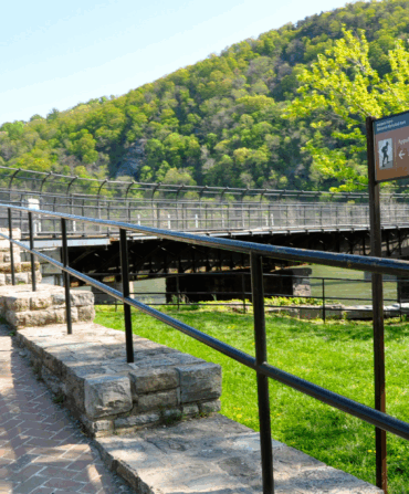 Two people hiking a trail with a brick path