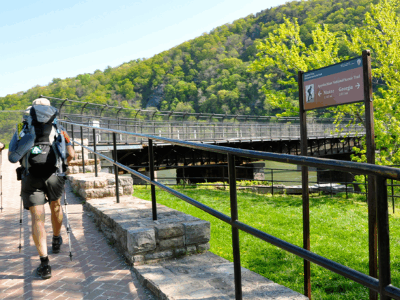 Two people hiking a trail with a brick path