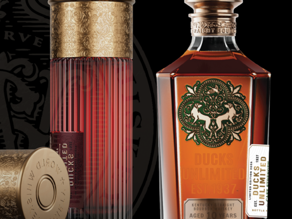 Two shotgun shell-shaped containers of whiskey and a bottle of bourbon