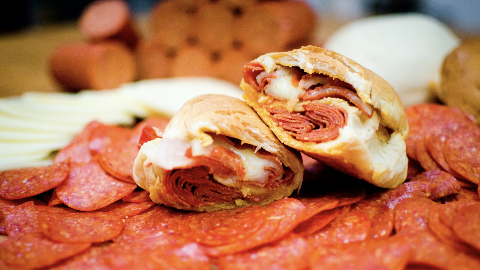 A pepperoni roll on a bed of pepperonis