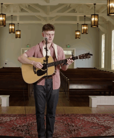 A man holds a guitar