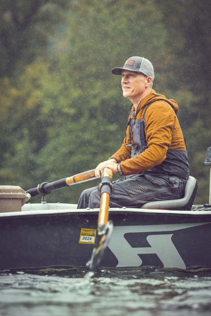 A man holding paddles in a boat