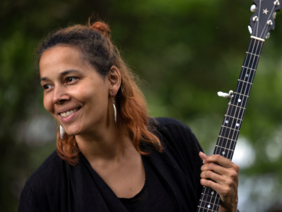 A woman holding a banjo